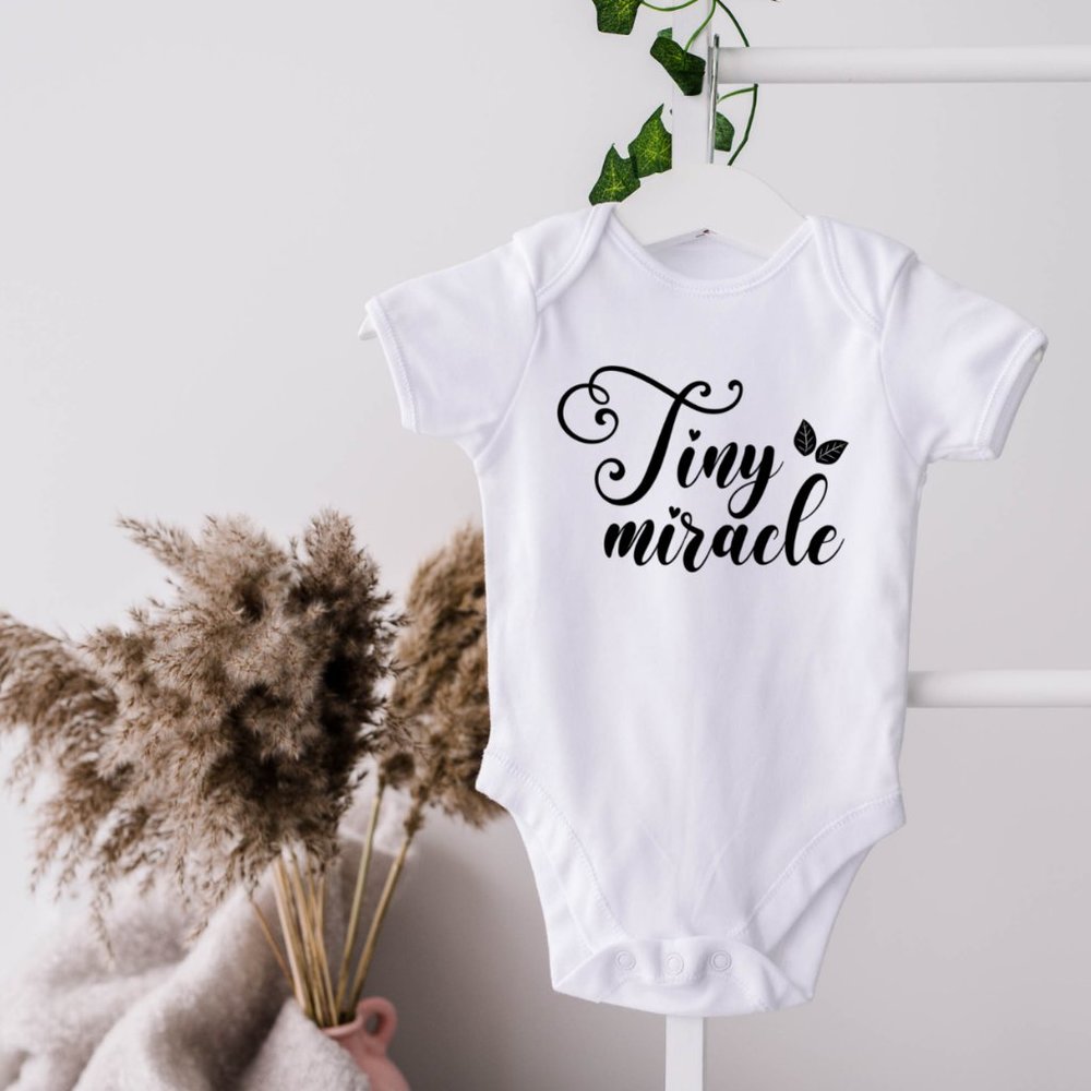 TINY LITTLE MIRACLE ONESIE